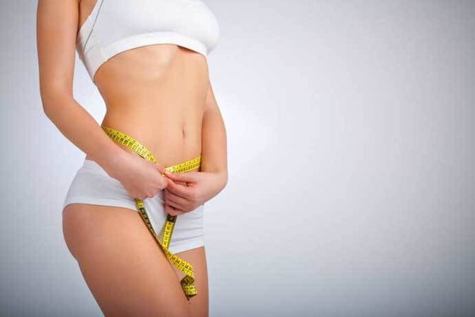 Gentle girl measures the waist volume